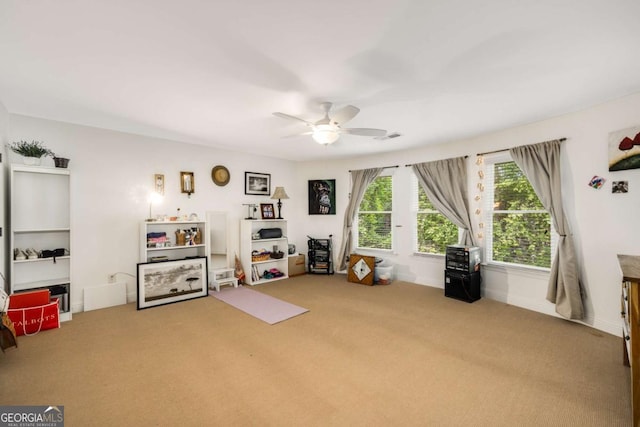 game room with carpet and a ceiling fan