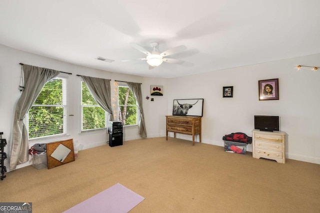 sitting room featuring carpet floors, a ceiling fan, and baseboards
