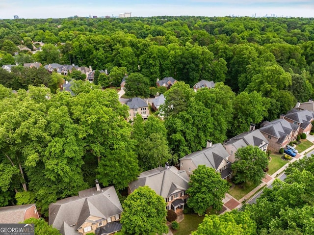 aerial view of residential area featuring a forest