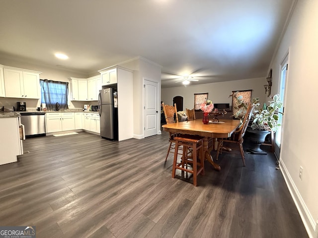 214 Evans St, Athens, GA 30606 - dining space featuring dark wood-type flooring, ceiling fan, baseboards, and ornamental molding