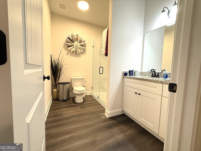 214 Evans St, Athens, GA 30606 - bathroom with toilet, wood finished floors, vanity, a shower stall, and baseboards