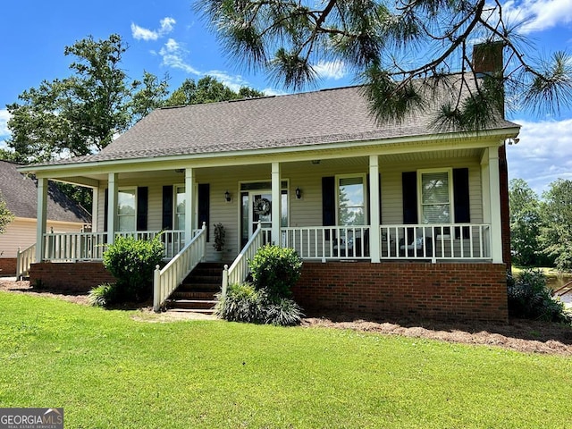 21 Pine Lake Rd, Tifton, GA 31793 - view of front of property featuring covered porch, a front yard, brick siding, and roof with shingles