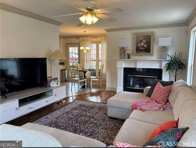 238 Covington Pl, Athens, GA 30606 - living area with wood finished floors, ornamental molding, a ceiling fan, a tile fireplace, and a chandelier