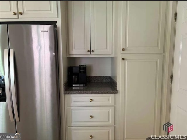 238 Covington Pl, Athens, GA 30606 - kitchen with stainless steel fridge with ice dispenser, dark countertops, and white cabinetry
