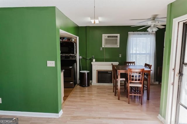 50 Canyon Pass, Cleveland, GA 30528 - dining space with an AC wall unit, a ceiling fan, light wood-style flooring, and baseboards