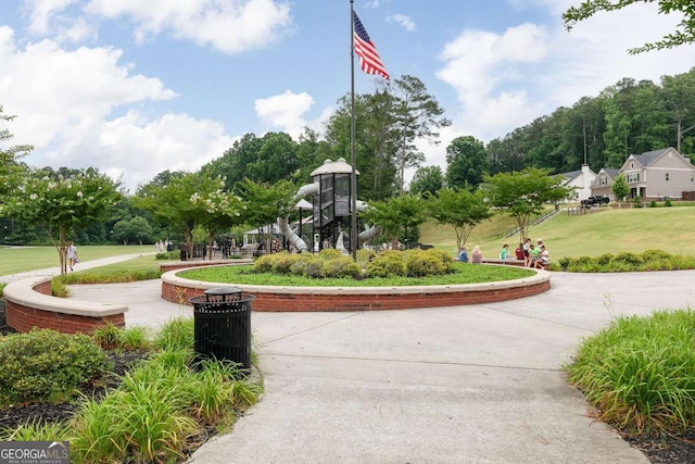 view of property's community with a lawn