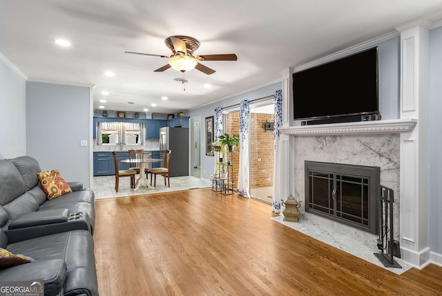 5401 Rosser Rd, Tucker, GA 30087 - living area with light wood-type flooring, ceiling fan, crown molding, a fireplace, and recessed lighting