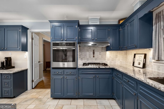 5401 Rosser Rd, Tucker, GA 30087 - kitchen featuring stainless steel appliances, blue cabinetry, under cabinet range hood, decorative backsplash, and light stone counters
