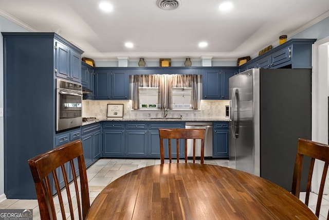 5401 Rosser Rd, Tucker, GA 30087 - kitchen with stainless steel appliances, blue cabinets, decorative backsplash, recessed lighting, and crown molding