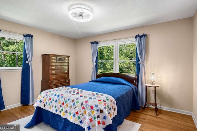 5401 Rosser Rd, Tucker, GA 30087 - bedroom featuring wood finished floors and multiple windows
