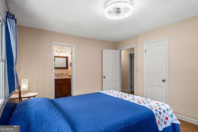 5401 Rosser Rd, Tucker, GA 30087 - bedroom featuring wood finished floors and connected bathroom