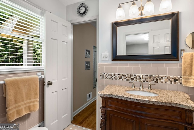 5401 Rosser Rd, Tucker, GA 30087 - bathroom featuring tile walls, vanity, and wood finished floors