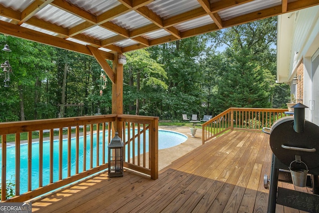 5401 Rosser Rd, Tucker, GA 30087 - wooden deck featuring an outdoor pool and view of wooded area