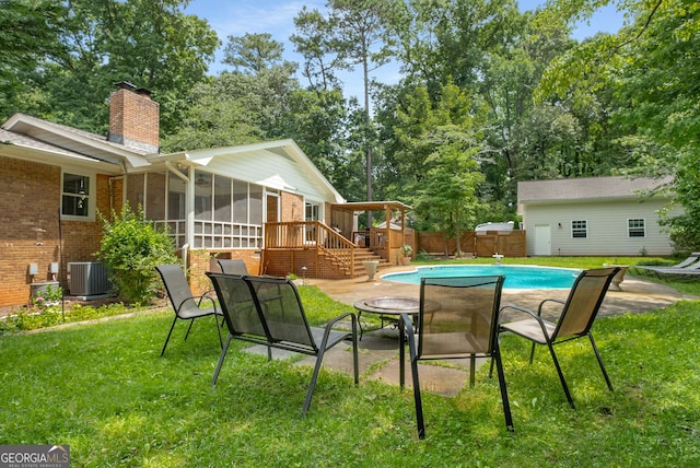 5401 Rosser Rd, Tucker, GA 30087 - view of swimming pool featuring a sunroom, a fenced backyard, a patio area, stairs, and view of wooded area