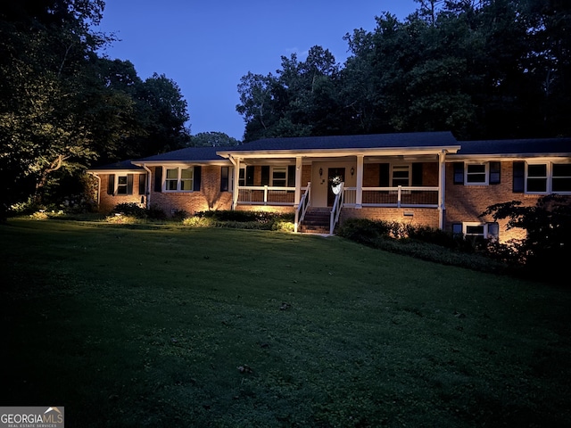 5401 Rosser Rd, Tucker, GA 30087 - ranch-style home featuring a porch, a front lawn, and brick siding