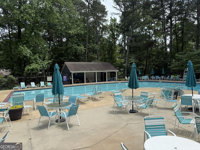 5401 Rosser Rd, Tucker, GA 30087 - community pool with a patio, view of wooded area, and outdoor dining space