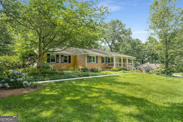5401 Rosser Rd, Tucker, GA 30087 - ranch-style home with a front lawn, covered porch, and brick siding