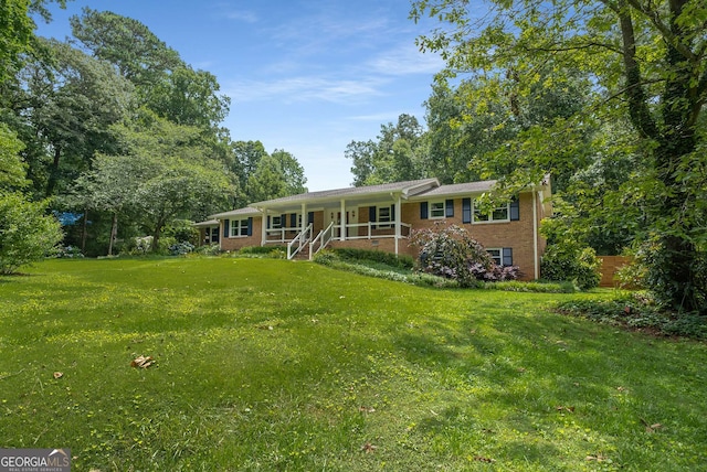 5401 Rosser Rd, Tucker, GA 30087 - ranch-style house featuring a porch, a front yard, and brick siding