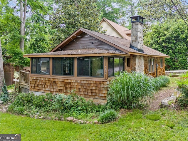 4624 Park Dr, Pine Lake, GA 30072 - view of front of home with a sunroom, a chimney, and roof with shingles
