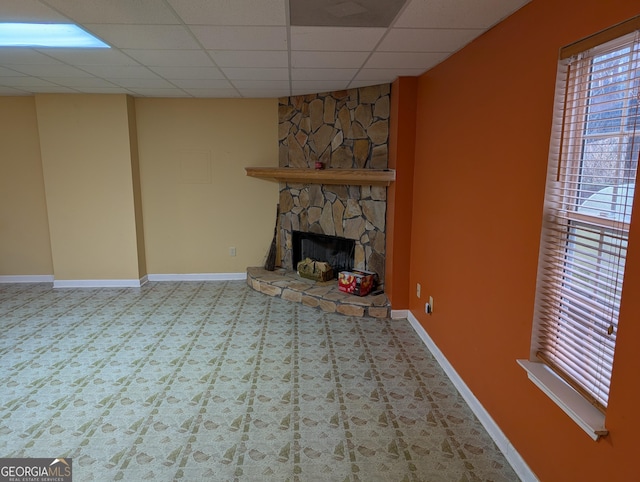5700 Miles Rd, South Fulton, GA 30349 - unfurnished living room featuring a paneled ceiling, a fireplace, and baseboards