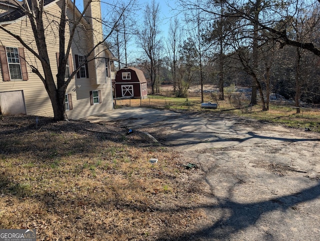 5700 Miles Rd, South Fulton, GA 30349 - view of yard featuring a barn, an outdoor structure, and driveway