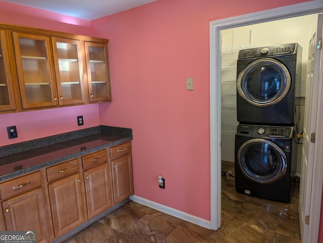 5700 Miles Rd, South Fulton, GA 30349 - laundry area featuring stacked washer / drying machine and baseboards