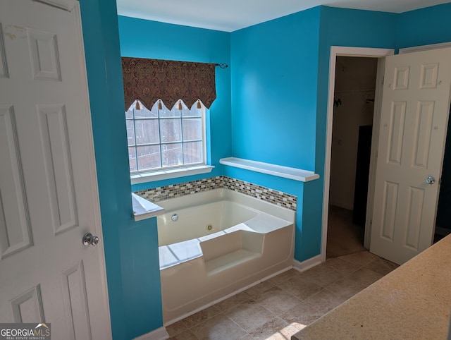 5700 Miles Rd, South Fulton, GA 30349 - bathroom featuring a tub with jets and tile patterned flooring