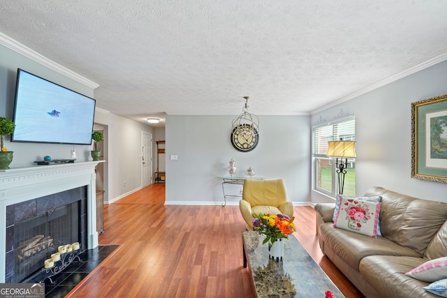 212 Brittany Ct, Duluth, GA 30096 - living room with wood finished floors, crown molding, a fireplace with flush hearth, a textured ceiling, and baseboards