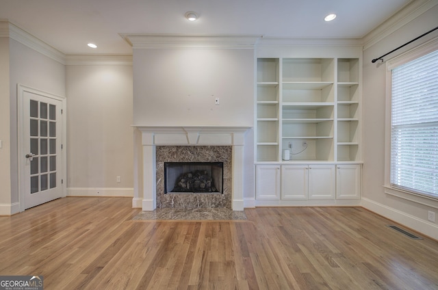 5492 Glenridge Dr Unit 536, Atlanta, GA 30342 - unfurnished living room featuring light wood-style flooring, plenty of natural light, baseboards, crown molding, and a premium fireplace
