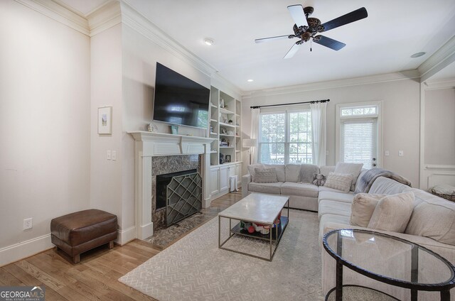 5492 Glenridge Dr Unit 536, Atlanta, GA 30342 - living room featuring wood finished floors, a high end fireplace, crown molding, ceiling fan, and baseboards