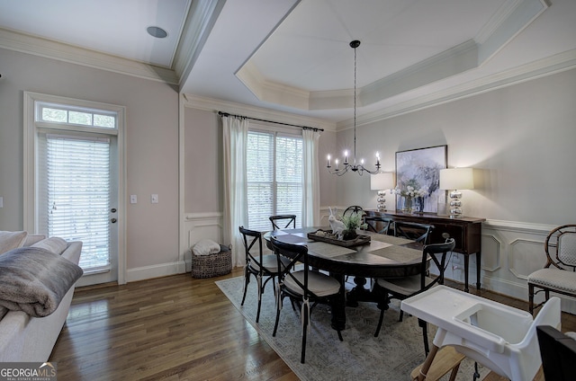 5492 Glenridge Dr Unit 536, Atlanta, GA 30342 - dining space featuring plenty of natural light, ornamental molding, a decorative wall, wood finished floors, and a chandelier