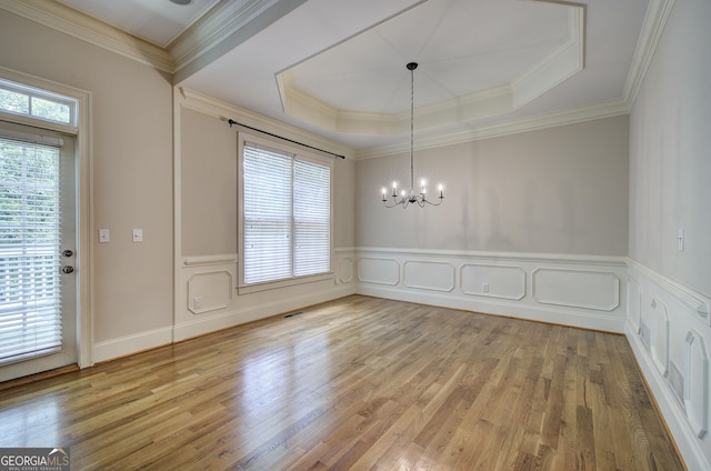 5492 Glenridge Dr Unit 536, Atlanta, GA 30342 - unfurnished dining area with a chandelier, light wood-style floors, wainscoting, a raised ceiling, and crown molding