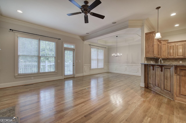 5492 Glenridge Dr Unit 536, Atlanta, GA 30342 - unfurnished living room with a ceiling fan, light wood-type flooring, ornamental molding, a chandelier, and a decorative wall