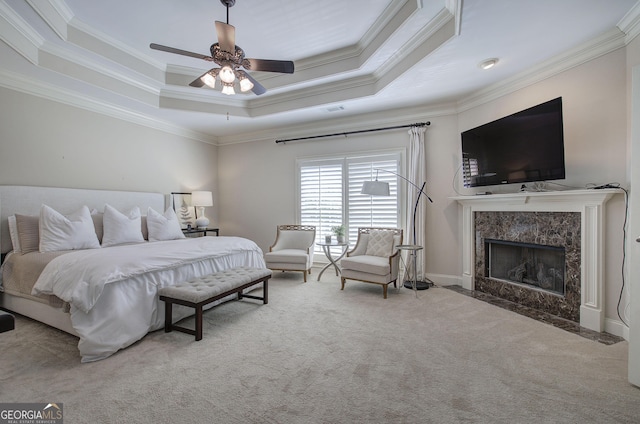 5492 Glenridge Dr Unit 536, Atlanta, GA 30342 - carpeted bedroom featuring ornamental molding, a tray ceiling, a fireplace, and a ceiling fan