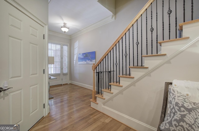 5492 Glenridge Dr Unit 536, Atlanta, GA 30342 - entrance foyer featuring crown molding, wood finished floors, stairs, and baseboards