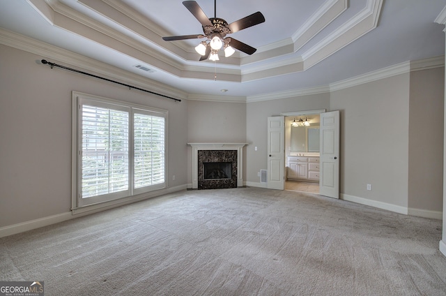 5492 Glenridge Dr Unit 536, Atlanta, GA 30342 - unfurnished living room with a raised ceiling, light carpet, a ceiling fan, ornamental molding, and a premium fireplace