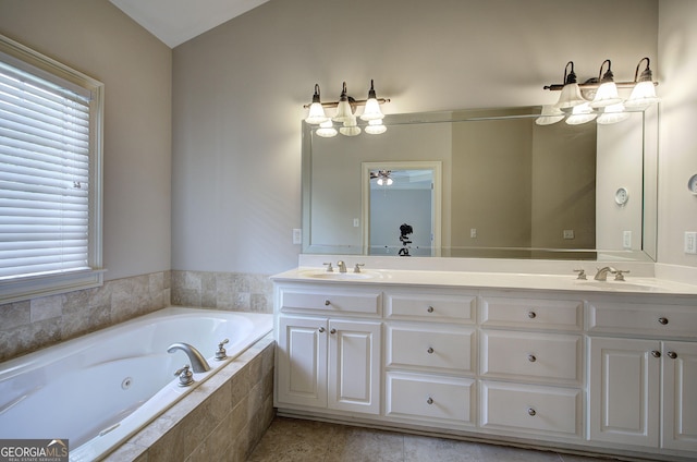 5492 Glenridge Dr Unit 536, Atlanta, GA 30342 - bathroom with healthy amount of natural light, double vanity, a tub with jets, ceiling fan, and vaulted ceiling