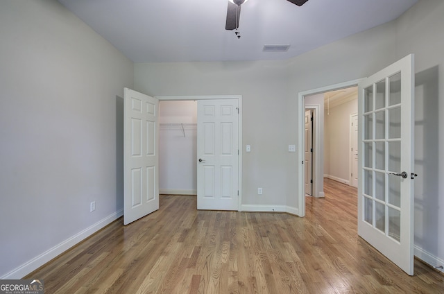 5492 Glenridge Dr Unit 536, Atlanta, GA 30342 - unfurnished bedroom featuring wood finished floors, french doors, baseboards, a closet, and a ceiling fan