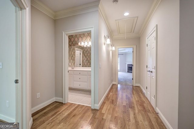 5492 Glenridge Dr Unit 536, Atlanta, GA 30342 - hallway featuring attic access, light wood-type flooring, ornamental molding, and baseboards