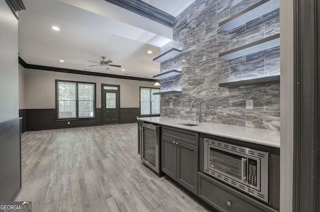 5492 Glenridge Dr Unit 536, Atlanta, GA 30342 - kitchen featuring a sink, ornamental molding, open shelves, beverage cooler, and wainscoting