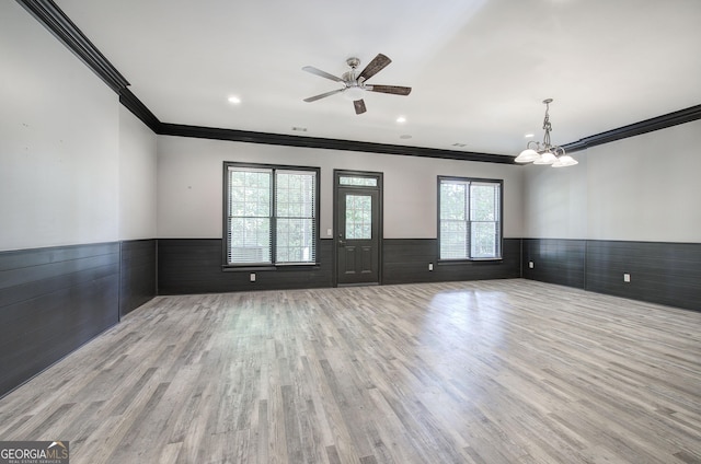 5492 Glenridge Dr Unit 536, Atlanta, GA 30342 - spare room with wainscoting, ornamental molding, wood finished floors, a ceiling fan, and a chandelier