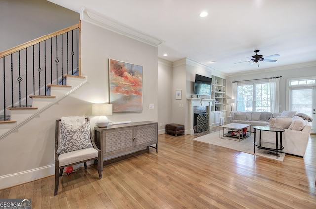 5492 Glenridge Dr Unit 536, Atlanta, GA 30342 - living area with crown molding, wood finished floors, recessed lighting, baseboards, and a fireplace with flush hearth