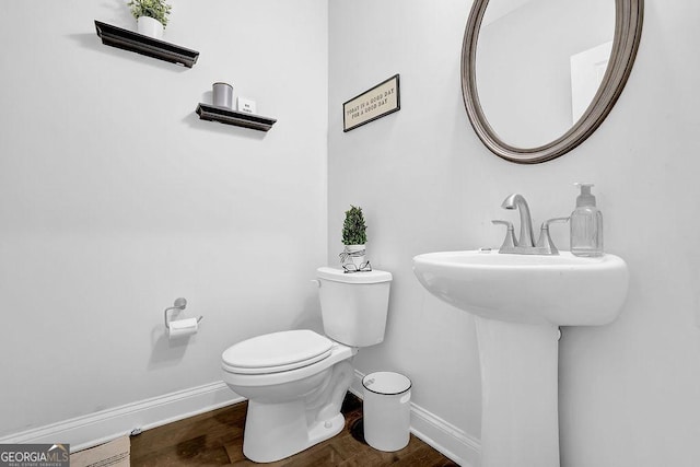 8745 Hightower Rdg, Ball Ground, GA 30107 - half bath with baseboards, toilet, and wood finished floors
