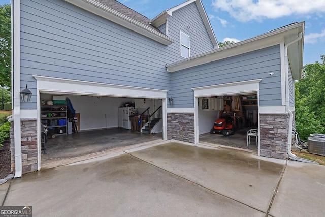 8745 Hightower Rdg, Ball Ground, GA 30107 - garage with cooling unit and concrete driveway
