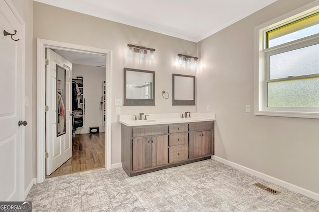 346 Rest Haven Rd, Thomaston, GA 30286 - bathroom with double vanity, crown molding, baseboards, and a spacious closet