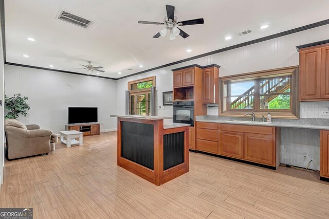 346 Rest Haven Rd, Thomaston, GA 30286 - kitchen featuring black oven, a sink, ceiling fan, crown molding, and light countertops