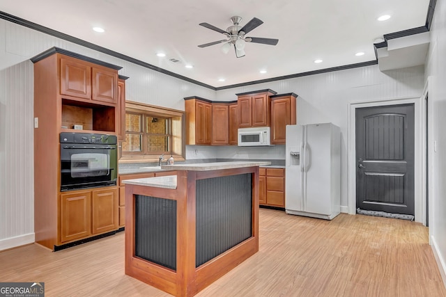 346 Rest Haven Rd, Thomaston, GA 30286 - kitchen with white appliances, crown molding, light wood-type flooring, a center island, and a sink