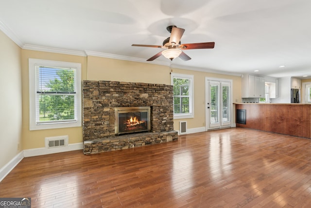 2055 Cactus Ln, Cumming, GA 30040 - unfurnished living room with a stone fireplace, crown molding, wood finished floors, and ceiling fan
