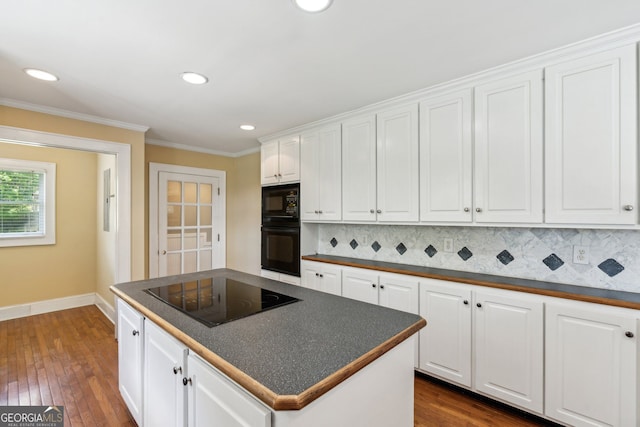2055 Cactus Ln, Cumming, GA 30040 - kitchen with black appliances, dark countertops, white cabinetry, decorative backsplash, and crown molding