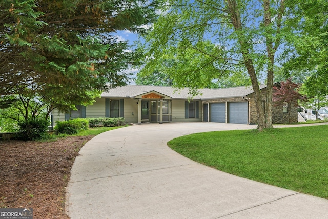 2055 Cactus Ln, Cumming, GA 30040 - ranch-style house featuring curved driveway, an attached garage, and a front lawn